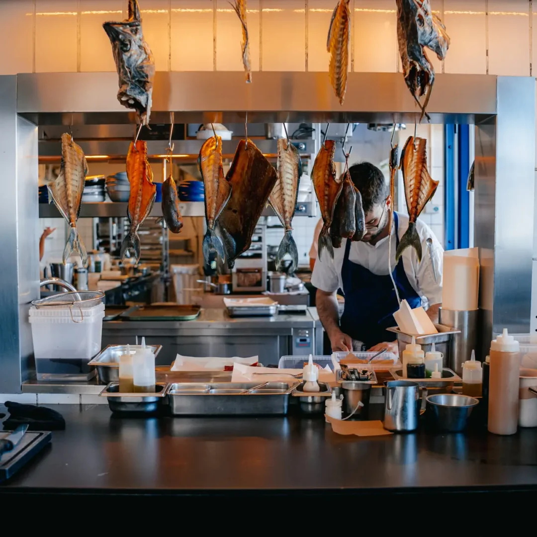 Cinematic food videography Copenhagen — whole fish kelp-glazed over fire